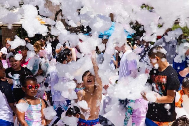 Kids having a blast at a crowded foam party event